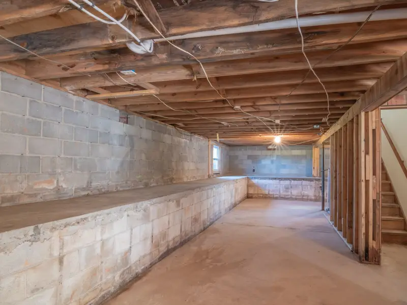 Low space under a raised house where ducts and drain lines run