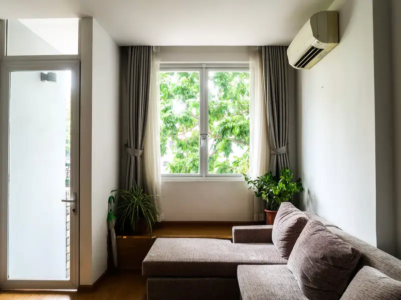 Ductless mini-split mounted high on a living room wall