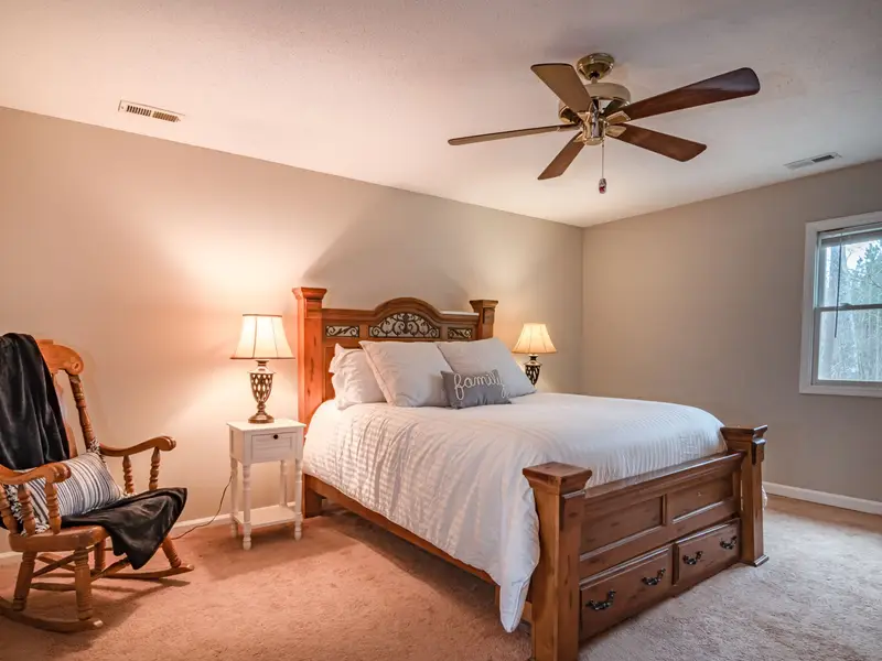 Bedroom with a ceiling fan turning on a hot afternoon