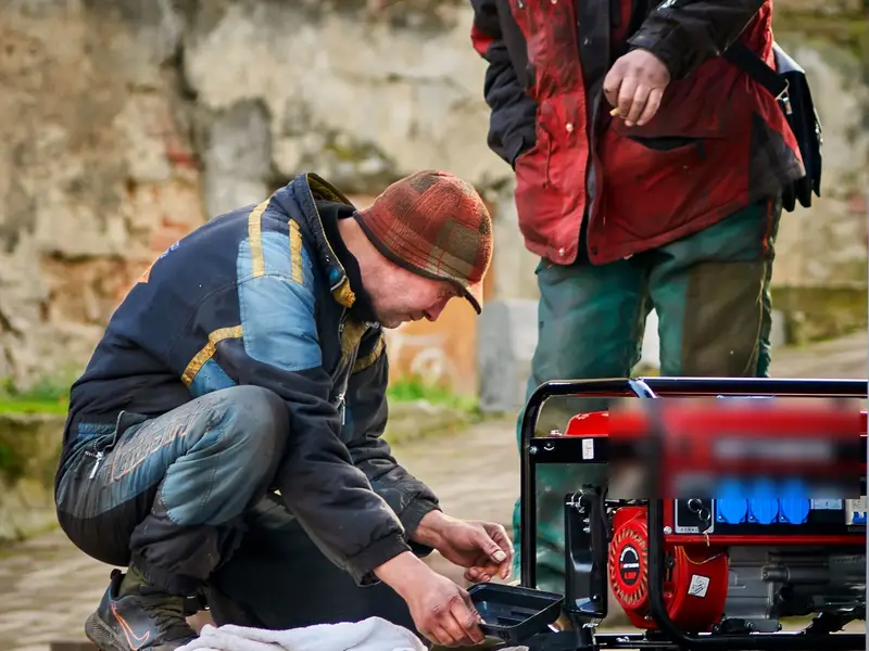 Portable generator being started outdoors