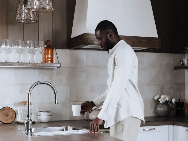 Homeowner at the kitchen counter of an older home