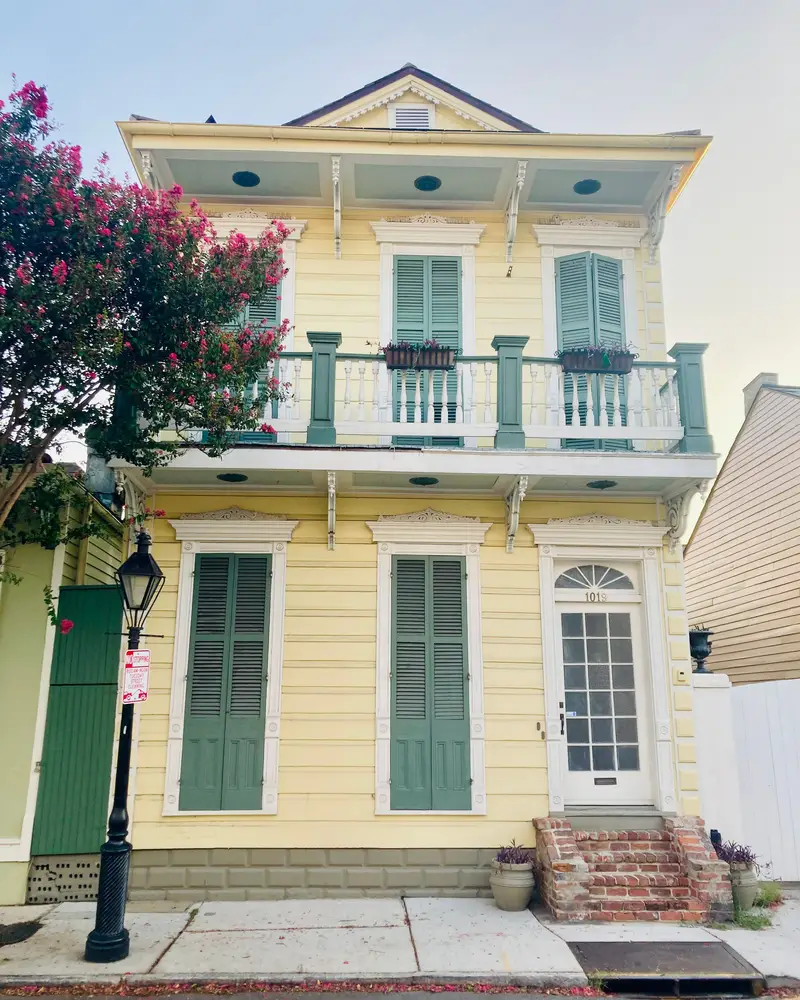 Pastel two-story house with a front balcony